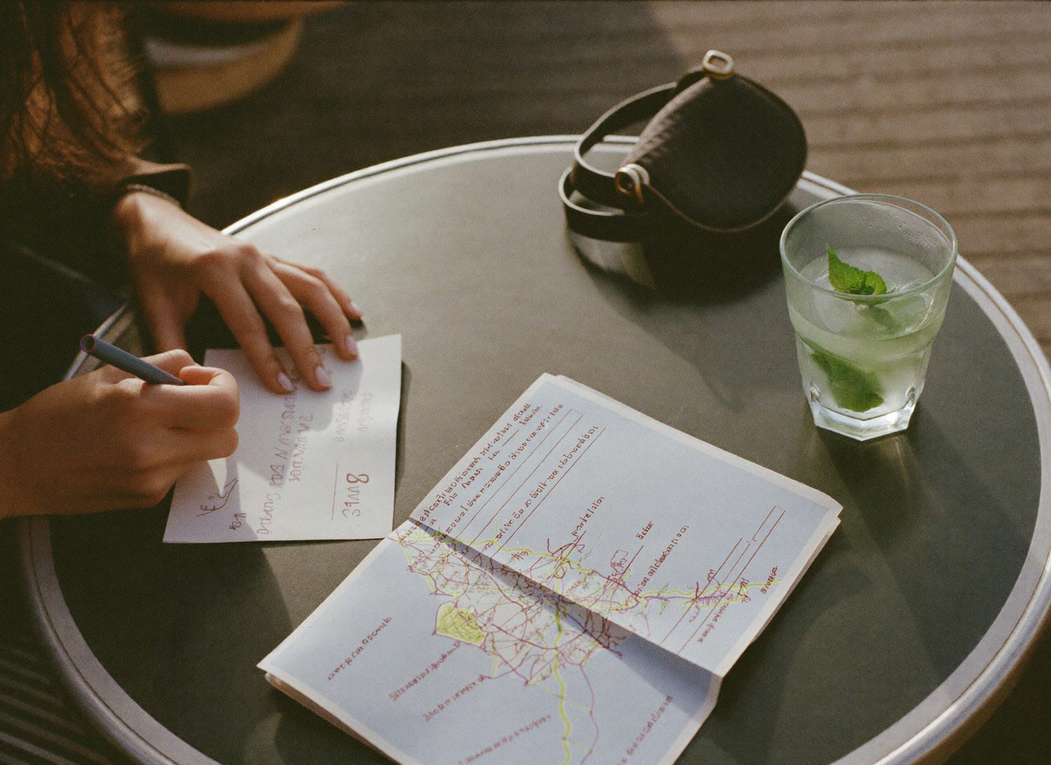 Planning a route over a map at a café table